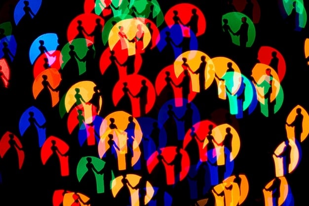 A graphic representing different customer personas, each with unique characteristics and demographics, placed against a backdrop of various social media logos.